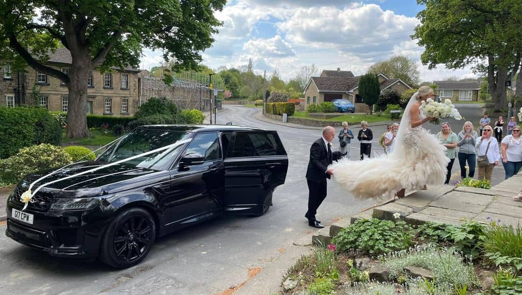 CPW Chauffeur Services Colin helping the bride to the church