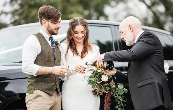 CPW Colin serving champagne to Bride & Groom