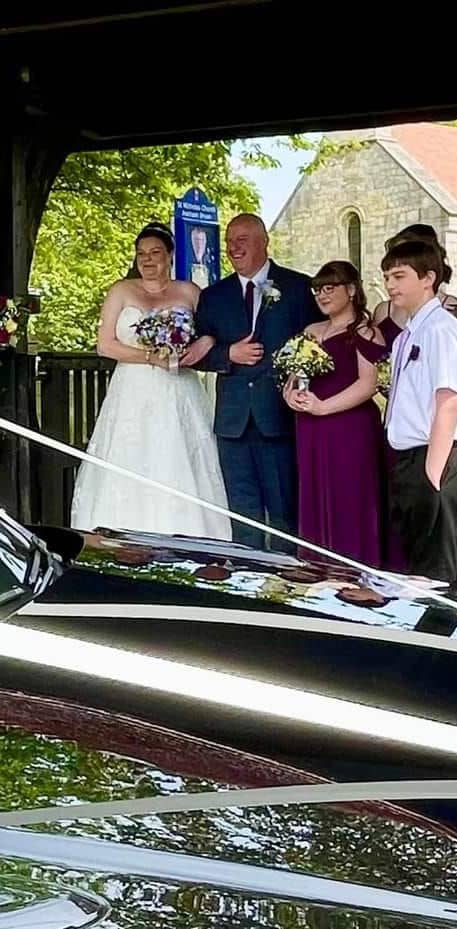 Bride Groom and friends looking at car